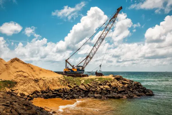 Dragline excavator working digging on the sea beach
